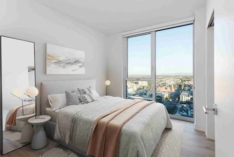 A bedroom with a large bed and a view of the city.