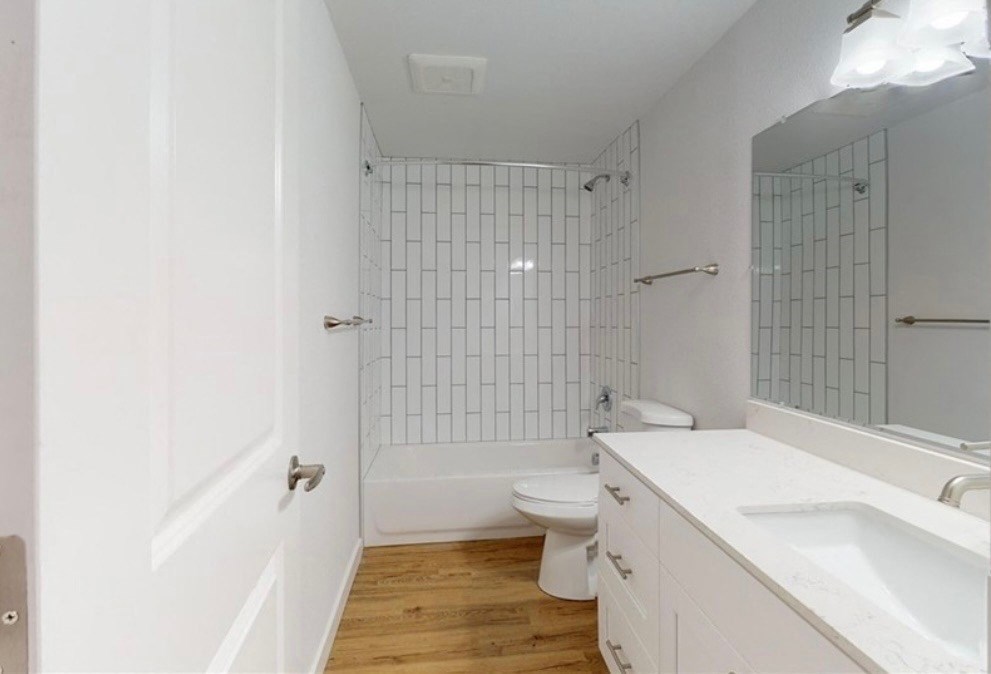 a white bathroom with a toilet and a sink