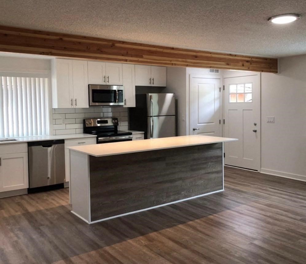 an empty kitchen with a counter top in the middle