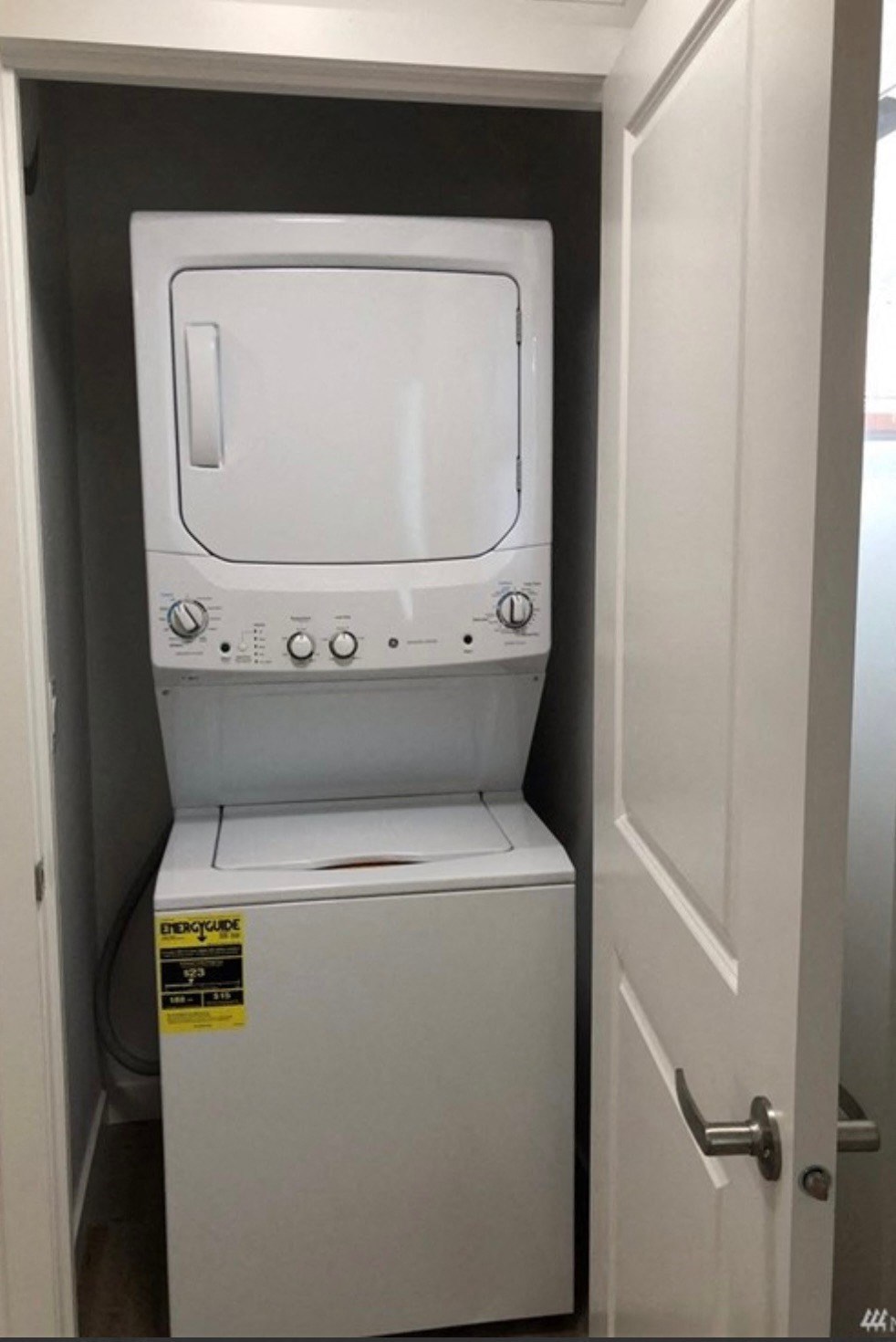 a white washer and dryer in a small closet