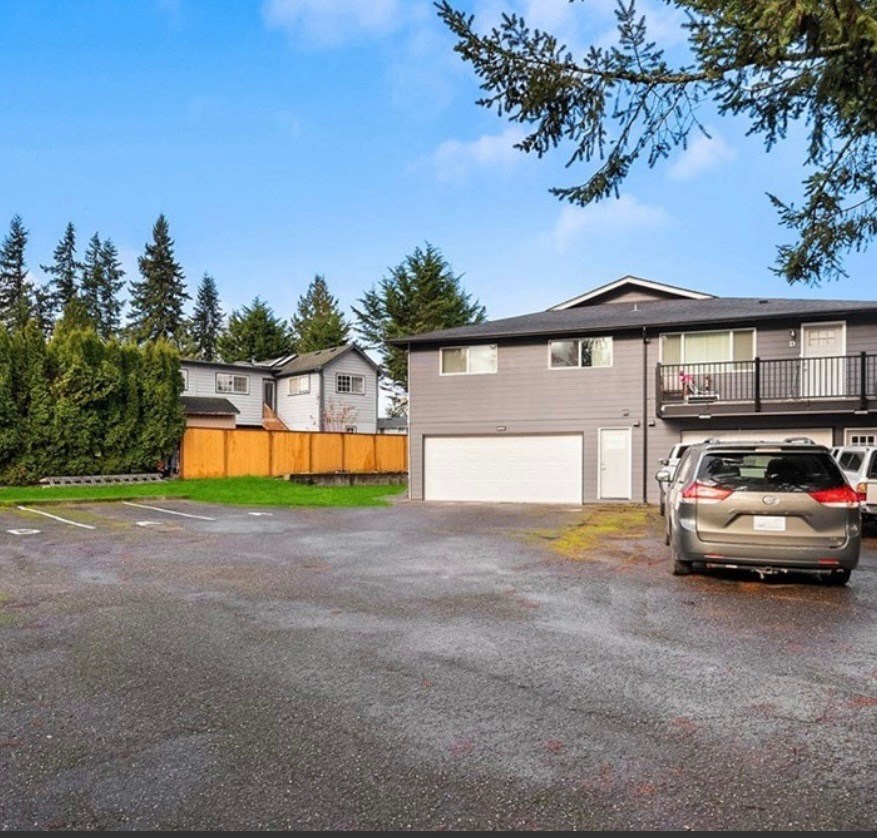 a car parked in a parking lot in front of a house