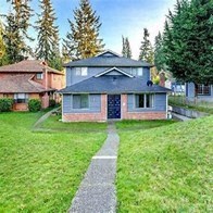 a brick house with a sidewalk in front of it