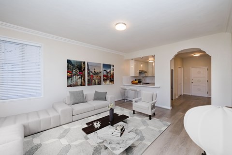 A living room with a white couch and a coffee table.