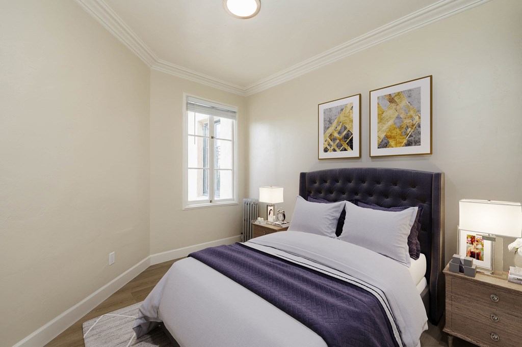 a bedroom with a bed and two pictures on the wall