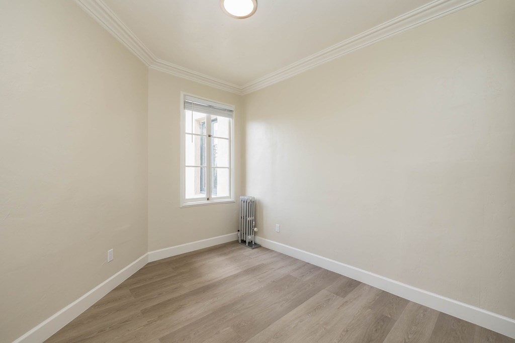 an empty room with white walls and a window