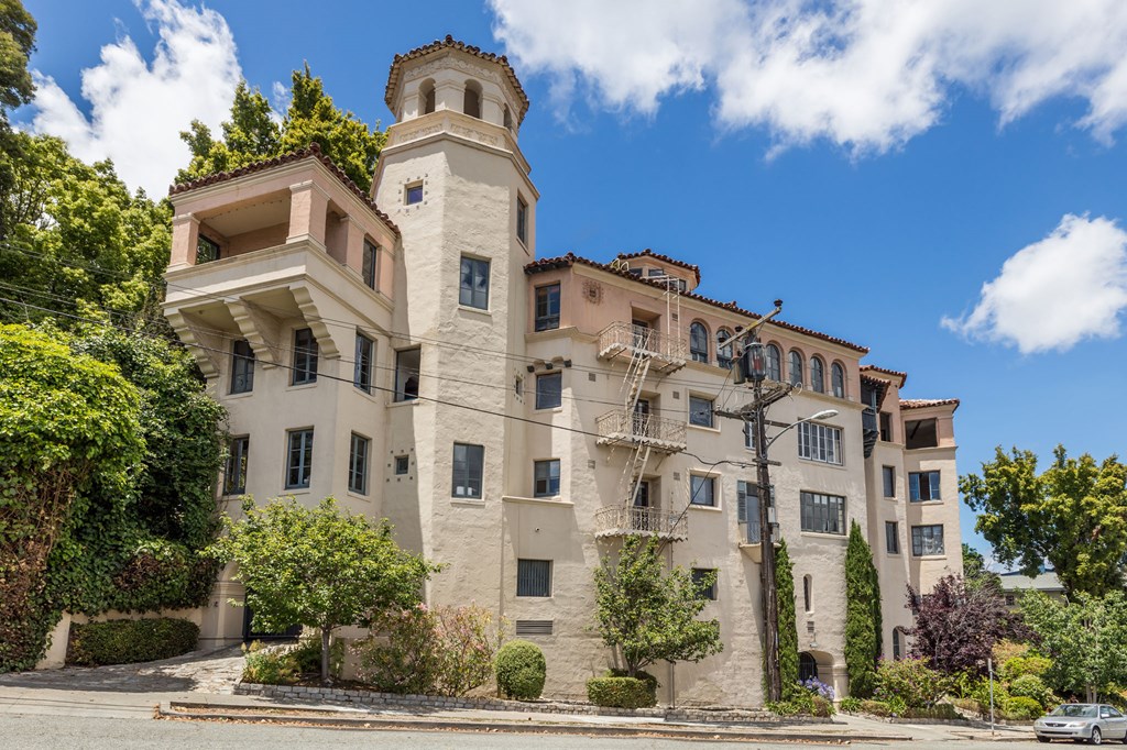 a large apartment building with a tower on top of it