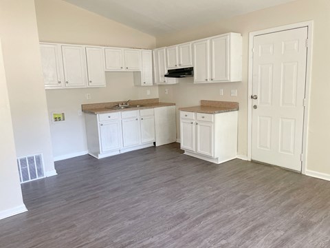A kitchen with white cabinets and a countertop.