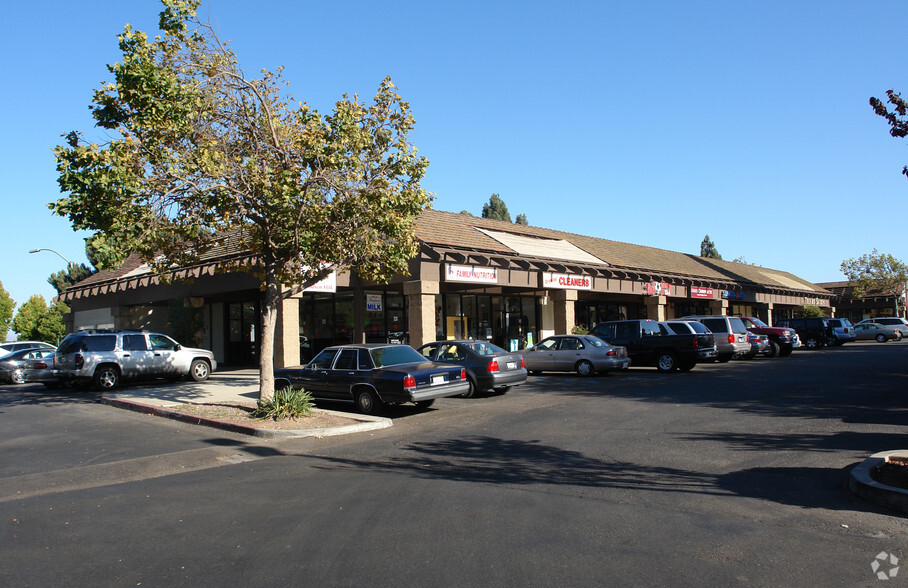 a parking lot with cars parked in front of a store