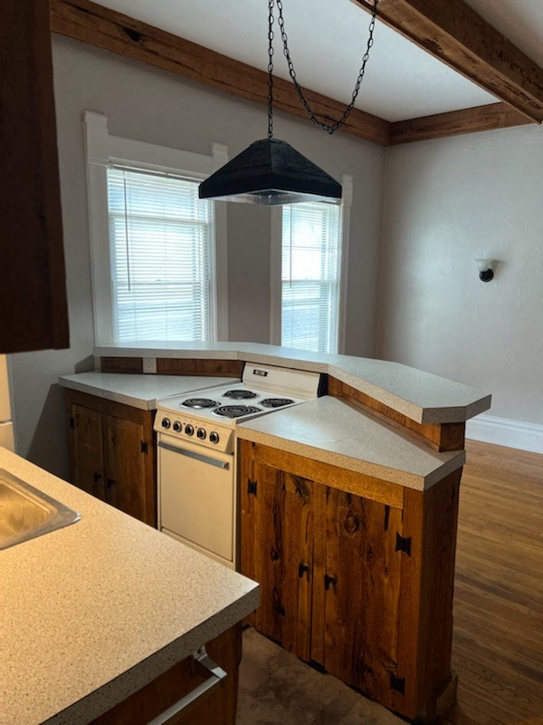 an empty kitchen with a stove and a window