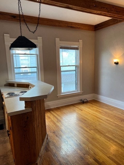 an empty room with a counter and a window