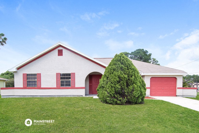 a red and white house with a red garage door