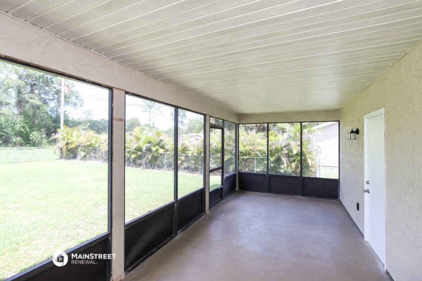 a room with large windows and a concrete floor