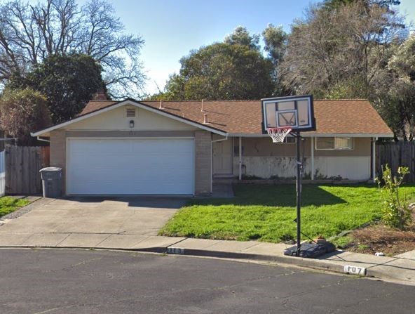 a house with a basketball hoop in front of it