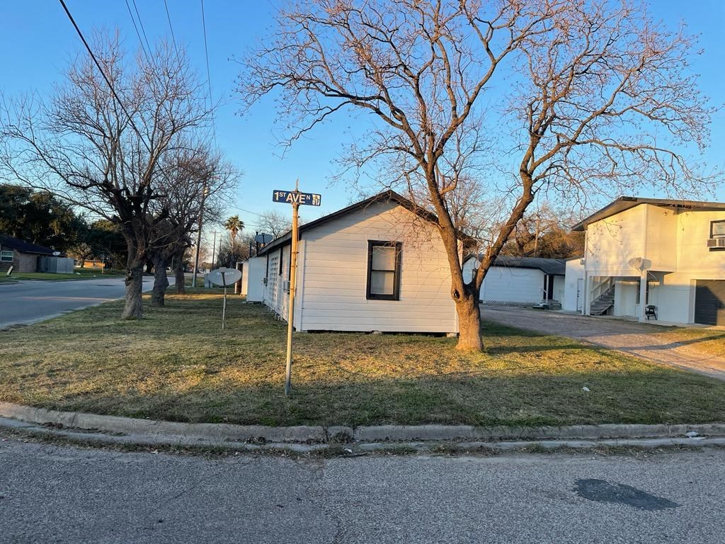 a house on the corner of a street with a street sign