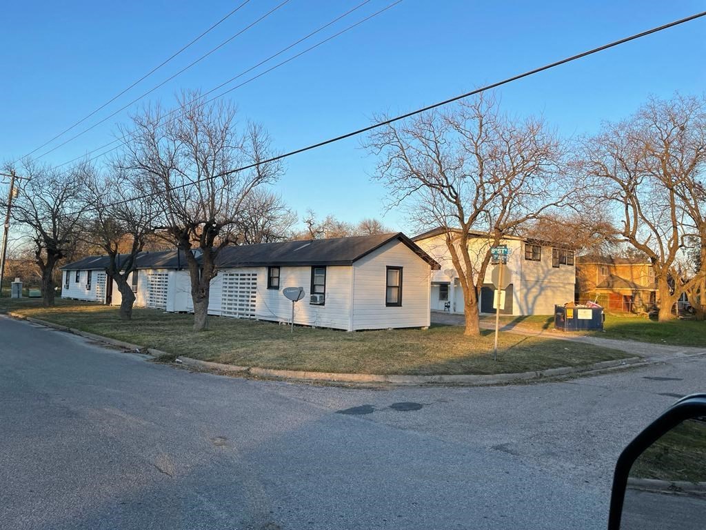 a white house on the corner of a street