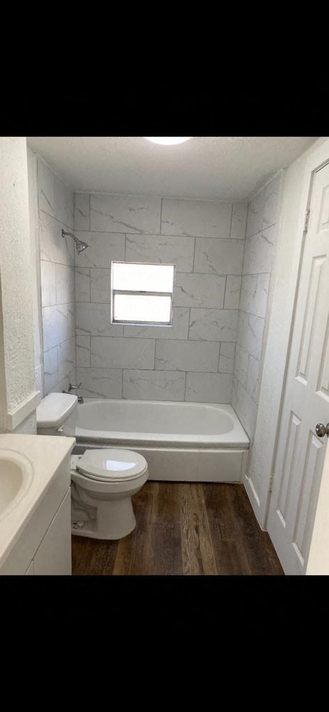 a small bathroom with a toilet and a bath tub
