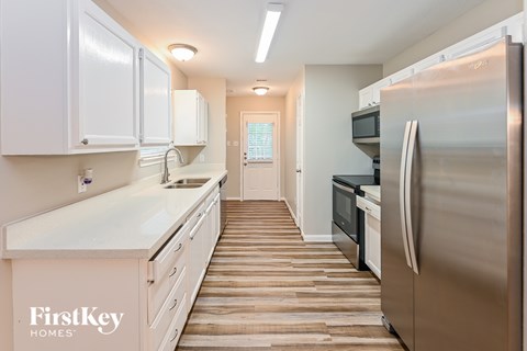 A kitchen with wooden floors and stainless steel appliances.
