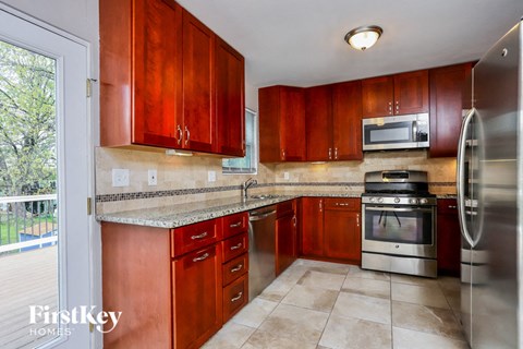 a kitchen with wooden cabinets and stainless steel appliances