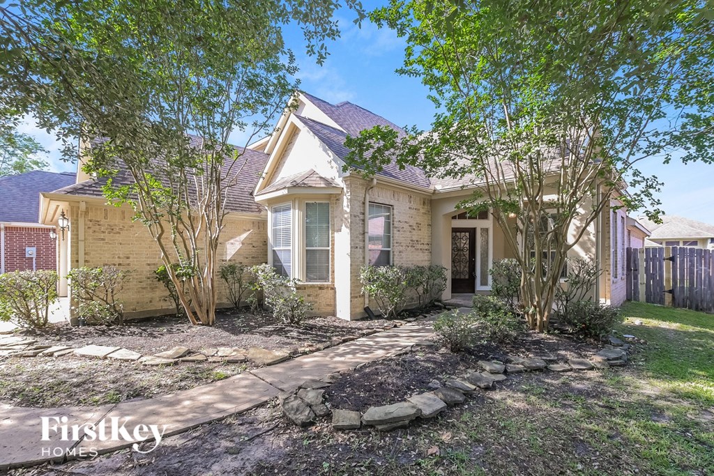 A house with a front yard and trees.