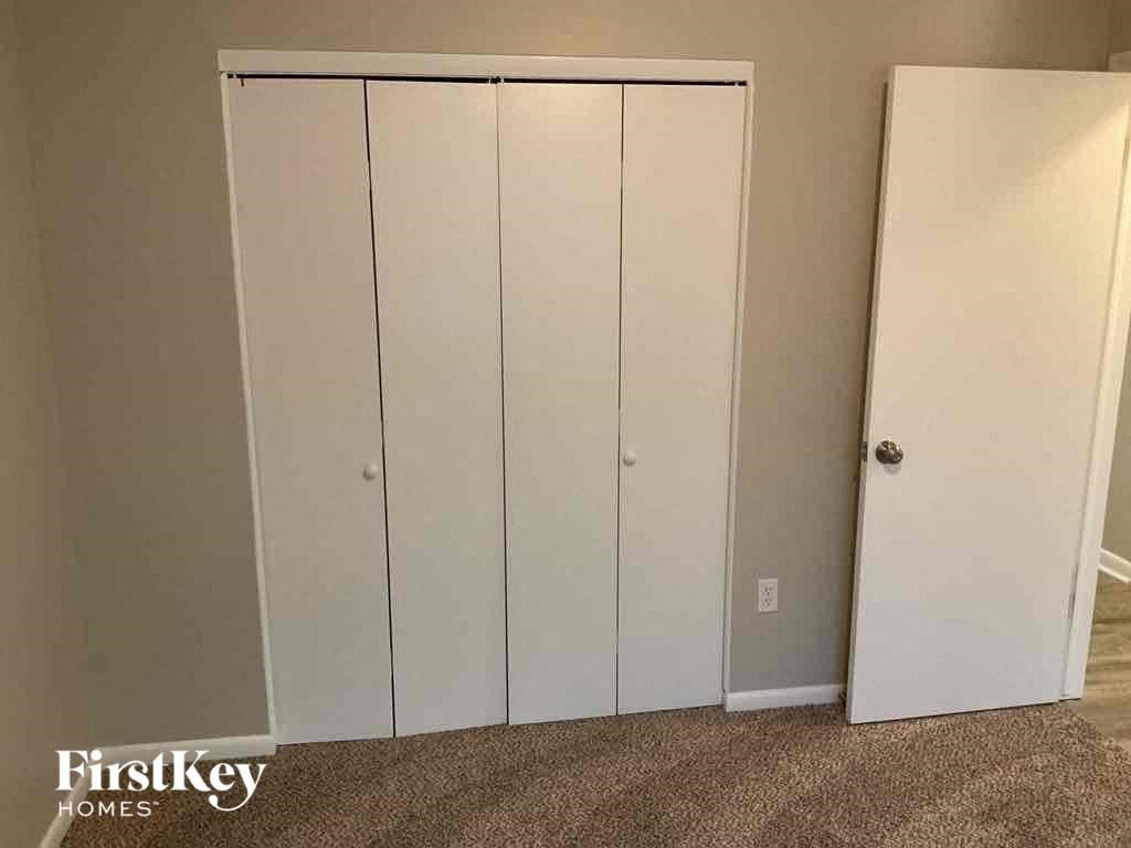 a set of three white closet doors in a room