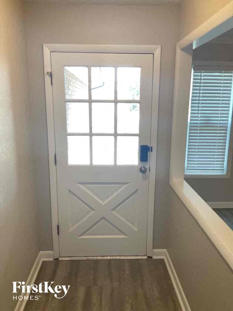 a white door in a hallway with a window