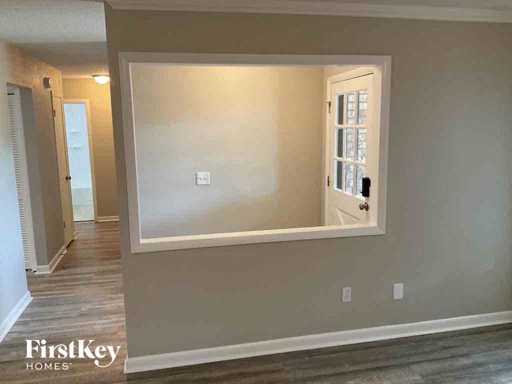 a large mirror in a room with a hallway and a door