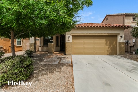 a garage door in front of a house with a tree