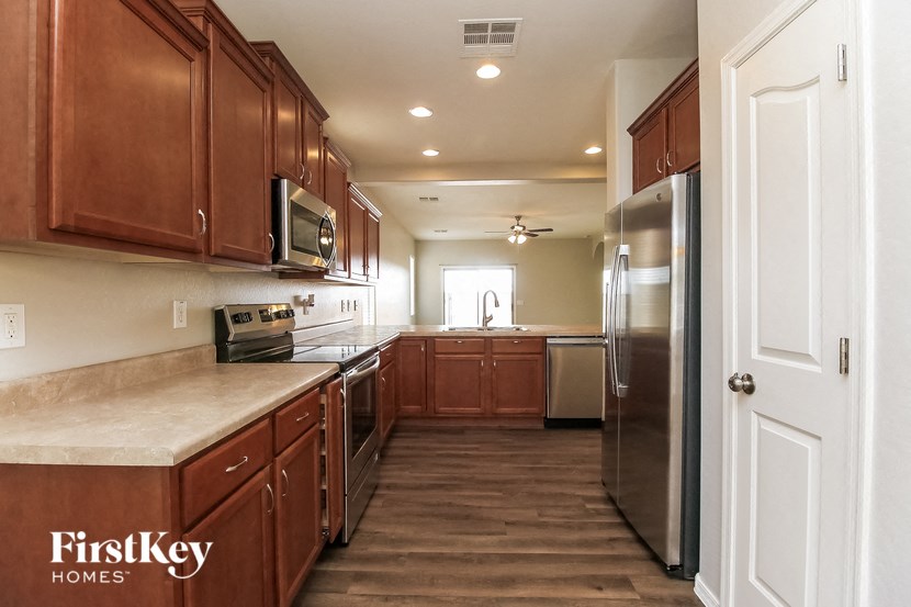 a kitchen with wooden cabinets and stainless steel appliances