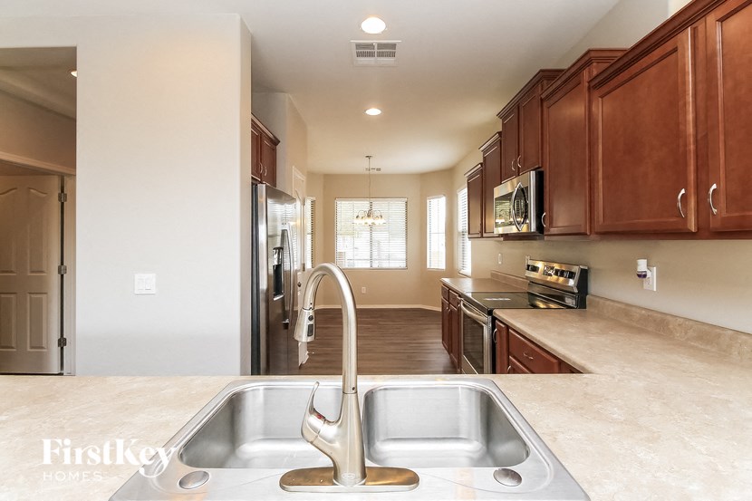 a kitchen with wooden cabinets and a stainless steel sink