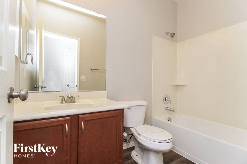 a bathroom with a sink toilet and a bath tub