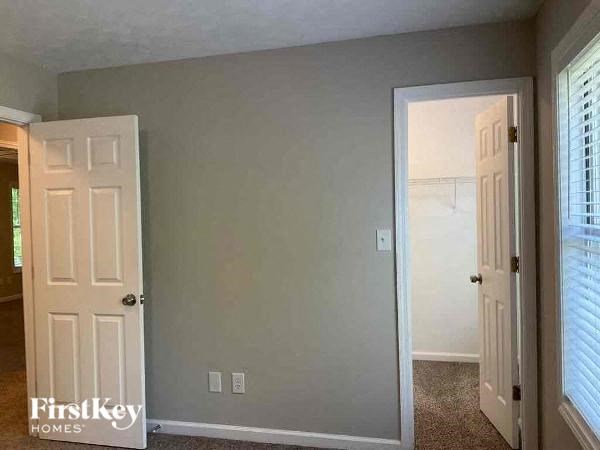 an empty room with a door and a closet