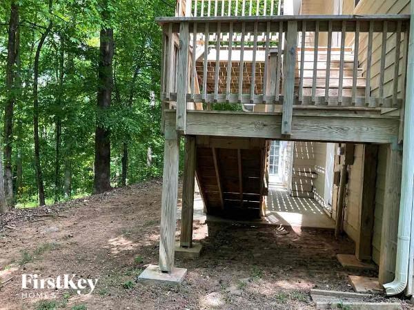 a house with a deck on top of a tree