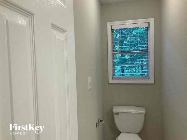a small bathroom with a toilet and a window