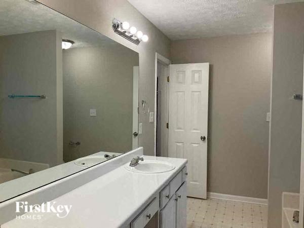 a bathroom with a white sink and a mirror