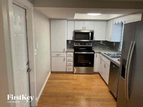 a kitchen with stainless steel appliances and white cabinets