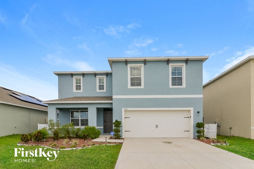 a blue house with a white garage door
