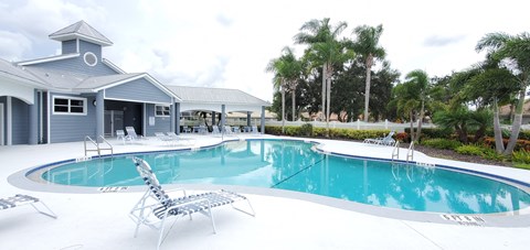 A large swimming pool with a small building next to it.