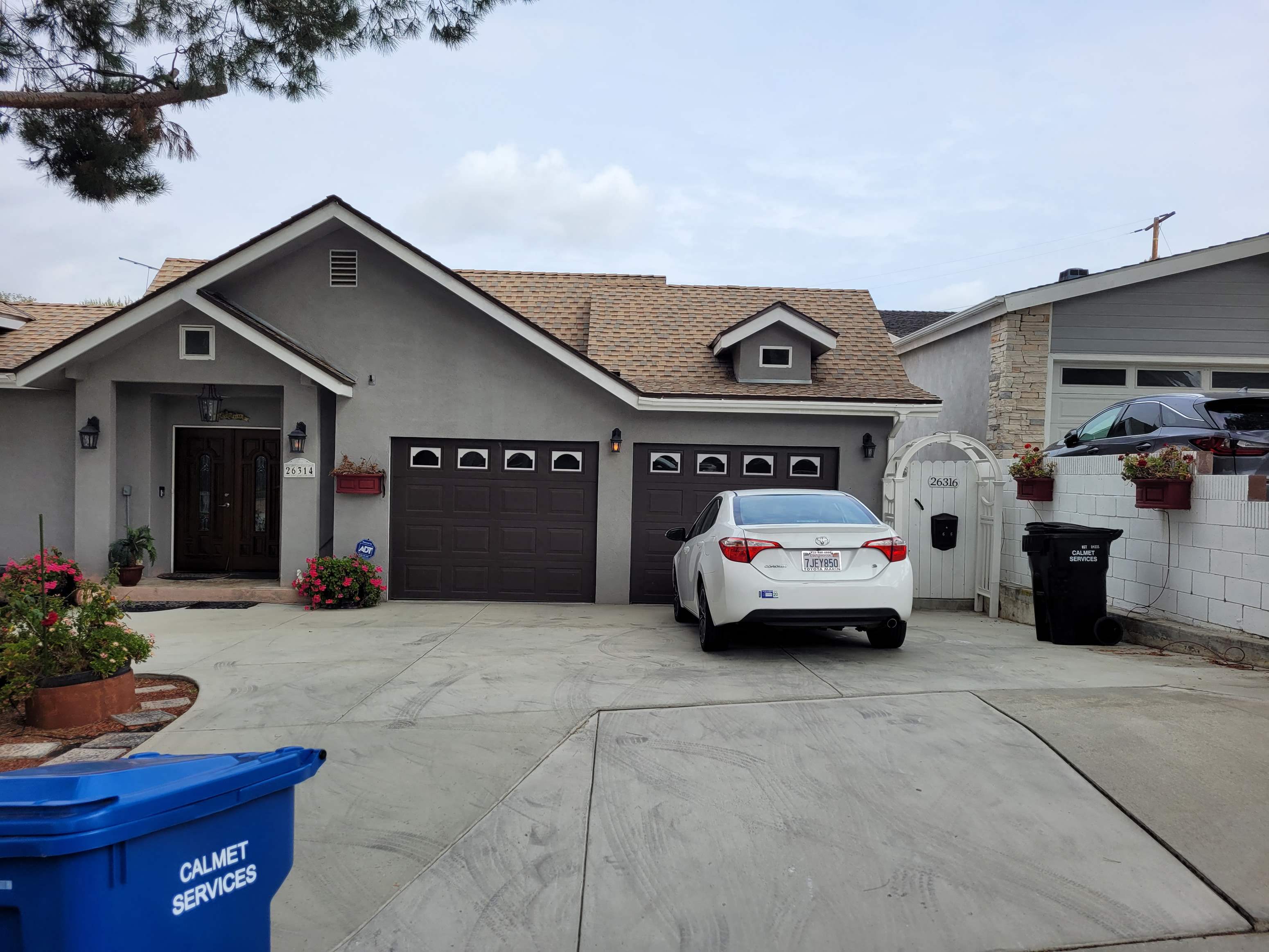a car parked in a driveway in front of a house