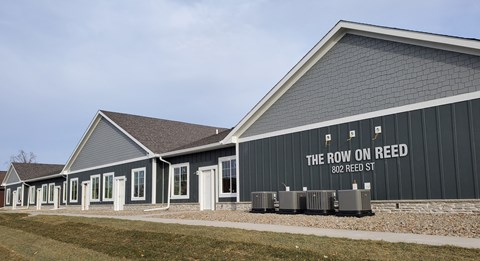 a building with a sign that reads the room on reel on the side of it