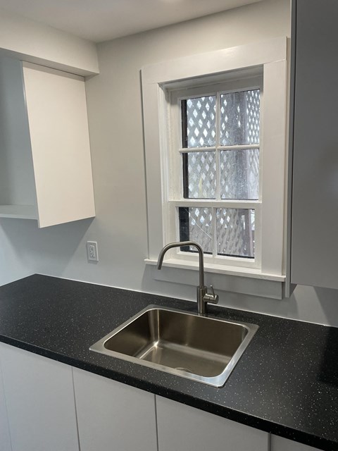 a window in a kitchen with a sink