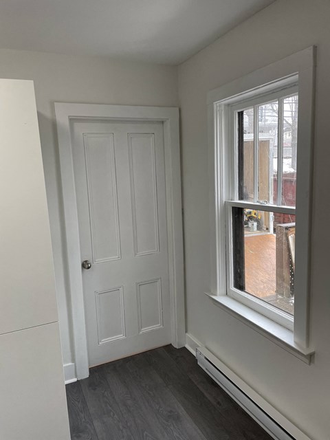 a room with a white door and a window