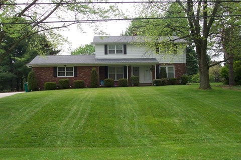 a house with a large lawn in front of it