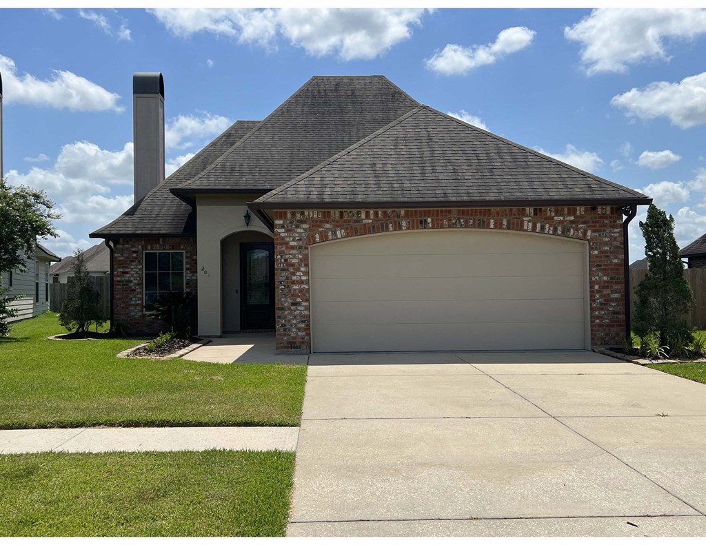 a white garage door on a brick house
