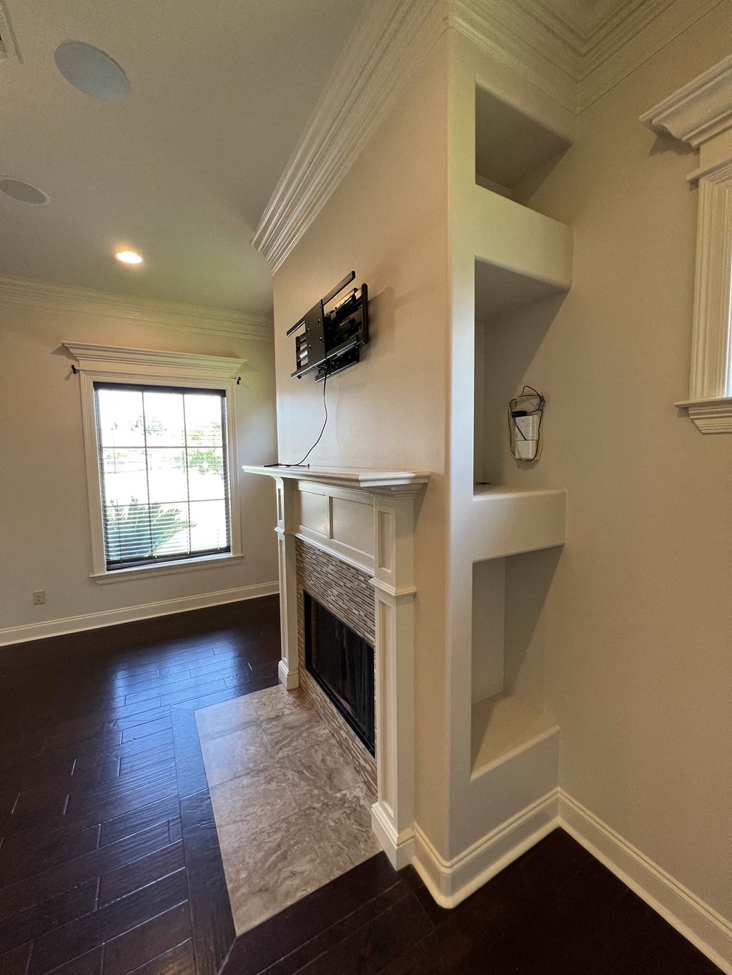 a living room with a fireplace and a tv