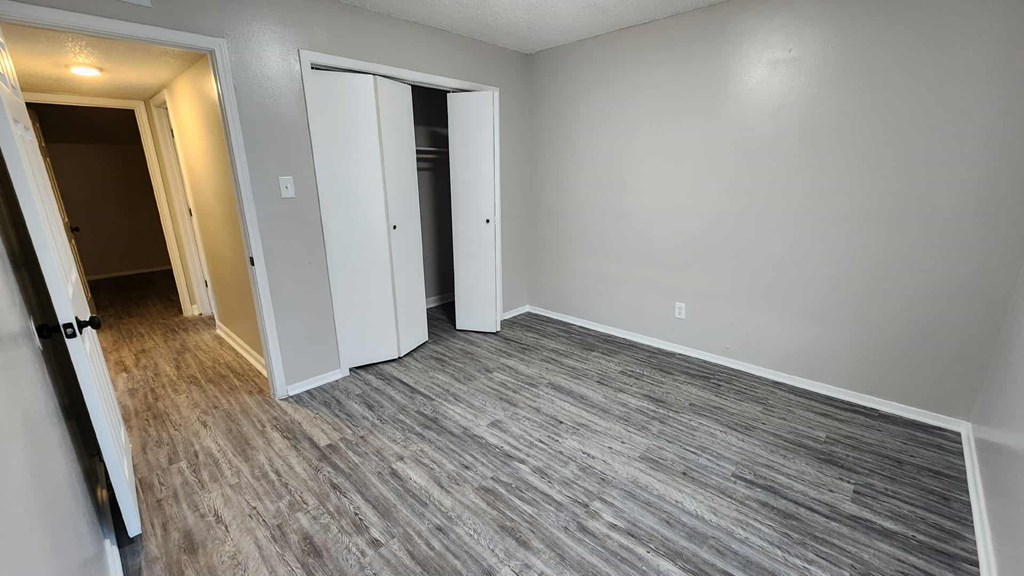 A room with grey flooring and white walls.