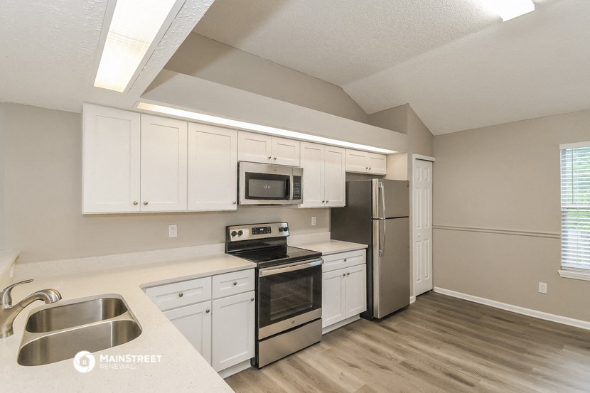 the kitchen of our studio apartment atrium with stainless steel appliances and white cabinets