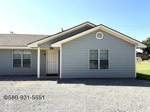 A small house with a white door and windows.