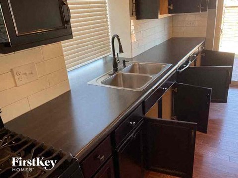 a kitchen with a stainless steel counter top and a sink