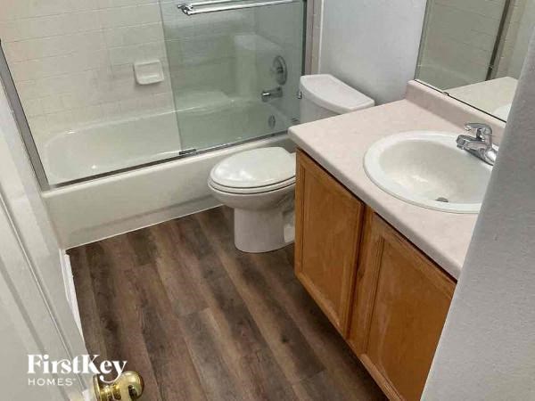 a bathroom with a toilet and a sink and a shower