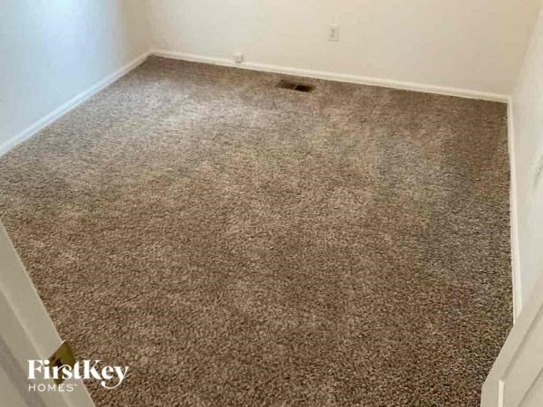 a carpeted floor in a room with a door